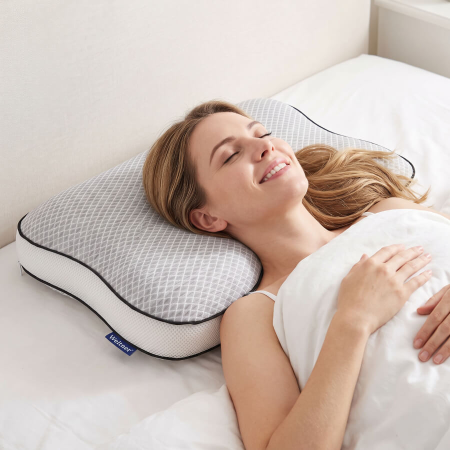 Žena spava na leđima na SmartSleep jastuku, glava leži u centralnom udubljenju a vrat je poduprt